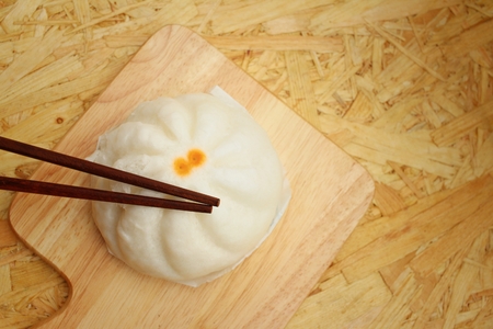 steamed dumpling - chinese bun on brown background.の写真素材
