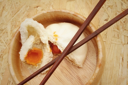 steamed dumpling - chinese bun on brown background.の写真素材