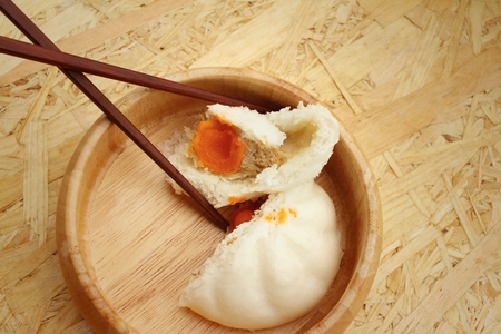 steamed dumpling - chinese bun on brown background.の写真素材
