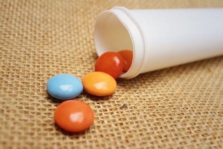 Colorful of chocolate isolated on brown backgroundの写真素材