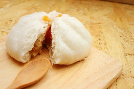 steamed dumpling - chinese bun on brown background.の写真素材