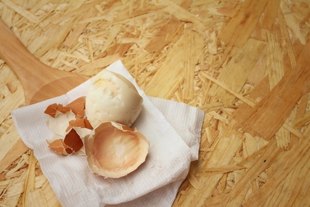 Boil egg on background of brown wooden.の写真素材