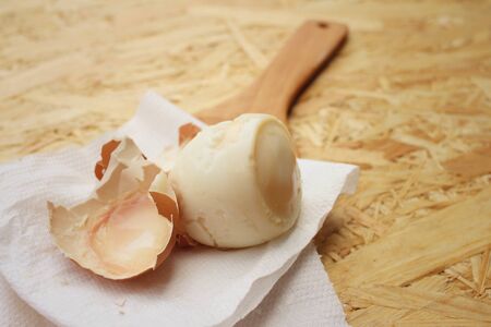 Boil egg on background of brown wooden.の写真素材