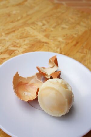 Boil egg in white plate on wooden background.の写真素材