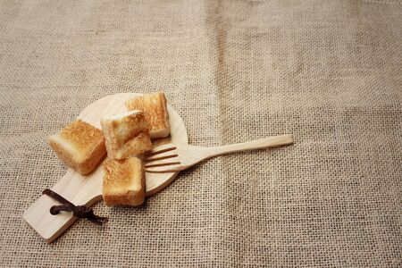 Breads in brown plate on wood background