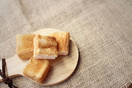 Breads in brown plate on wood backgroundの写真素材