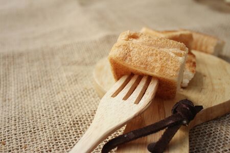 Breads in brown plate on wood backgroundの写真素材