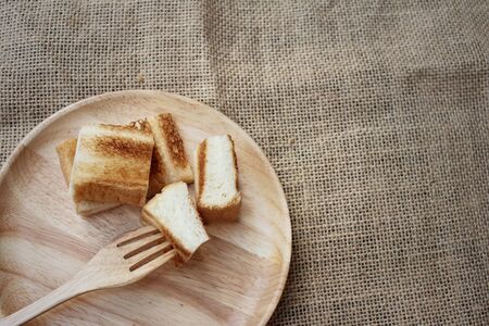 Breads in brown plate on wood background