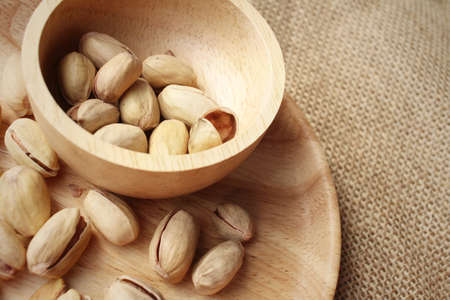 Pistachios nuts on a background of brownの写真素材