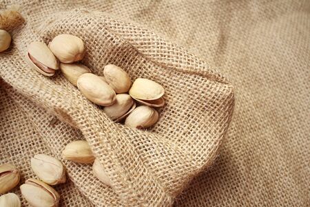 Pistachios nuts on a background of brownの写真素材