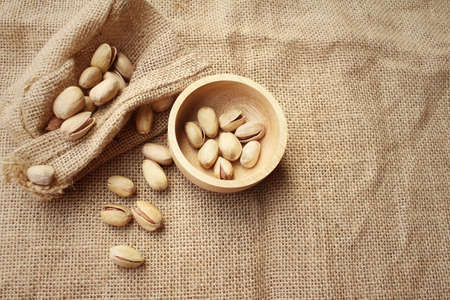 Pistachios nuts on a background of brownの写真素材