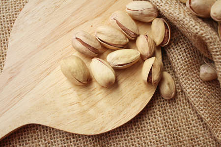 Pistachios nuts on a background of brownの写真素材