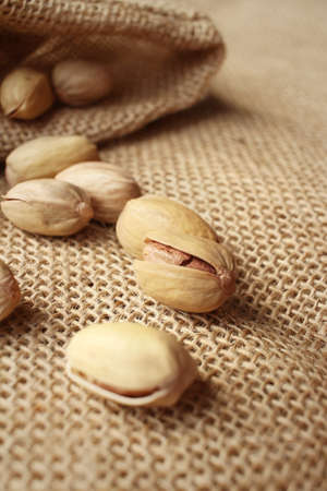 Pistachios nuts on a background of brownの写真素材