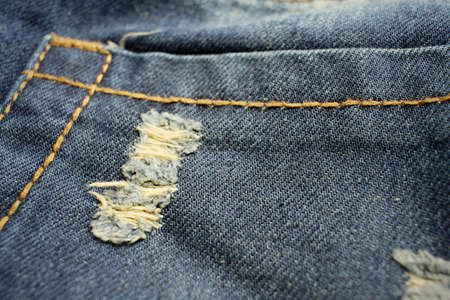 Background or texture of blue torn jeans.の写真素材