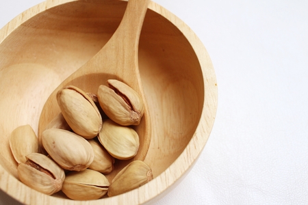 Pistachios nuts on a background of whiteの写真素材