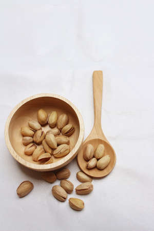 Pistachios nuts on a background of whiteの写真素材
