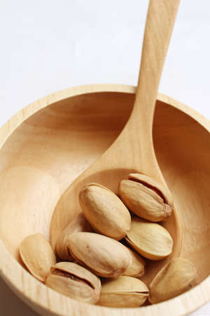 Pistachios nuts on a background of whiteの写真素材
