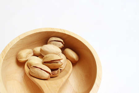 Pistachios nuts on a background of whiteの写真素材
