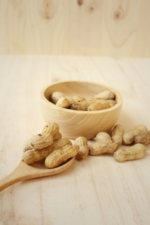Peanut on background of a brown wood.の写真素材