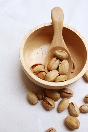 Pistachios nuts on a background of whiteの写真素材