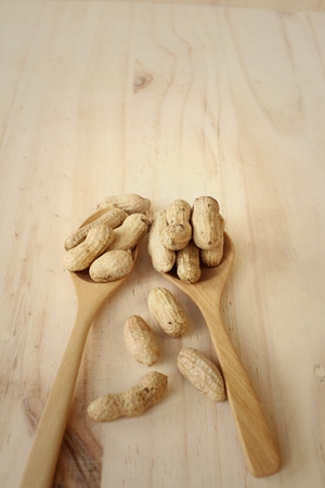 Peanut on background of a brown wood.の写真素材