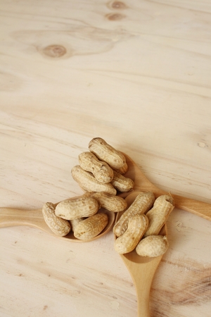 Peanut on background of a brown wood.の写真素材