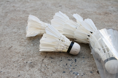 Shuttlecock on cement background at badminton court.