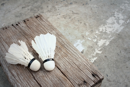 Shuttlecock on cement background at badminton court.