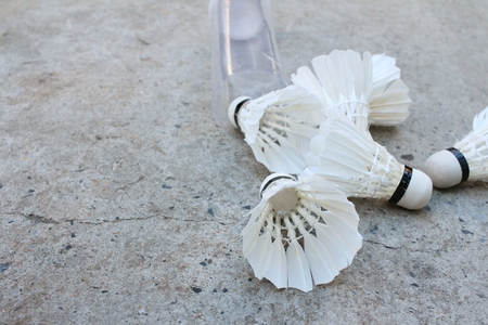 Shuttlecock on cement background at badminton court.