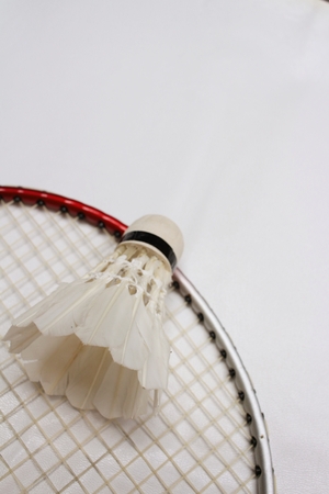 Shuttlecock and badminton racket on white background.の写真素材
