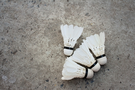 Shuttlecock on cement background at badminton court.