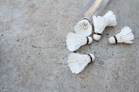 Shuttlecock on cement background at badminton court.