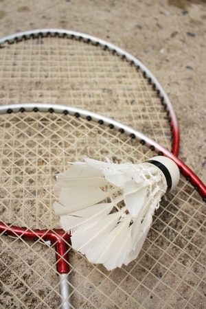 Shuttlecock and badminton racket on cement background.の写真素材
