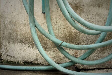 Garden hose for watering plants at the park.