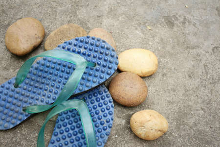 Blue slippers on background of old cement.の写真素材