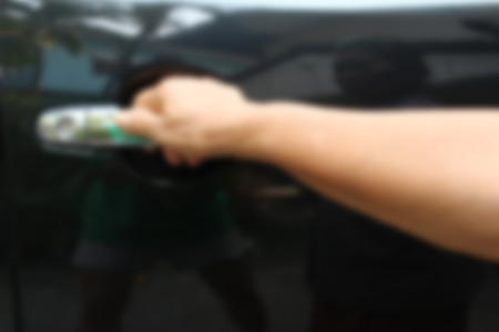 Blurred of male hand opening car door.の写真素材