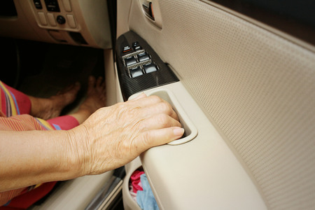 Woman is closing the car door in a carの写真素材