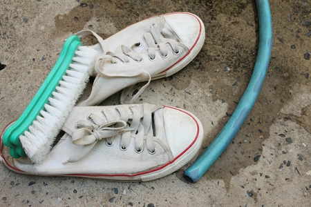 Sneakers are wash on a cement floor.の写真素材