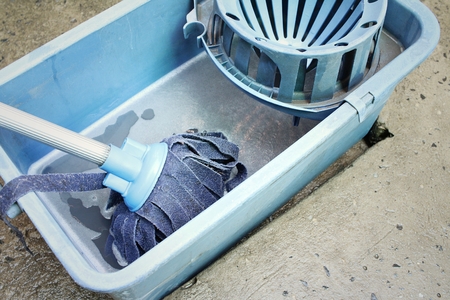 Blue bucket with cleaning mop for cleaning