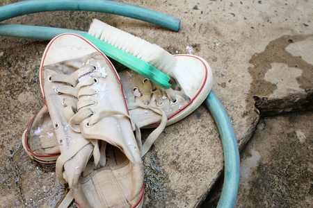 Sneakers are wash on a cement floor.の写真素材