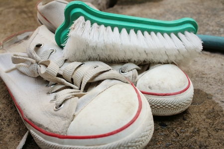 Sneakers are wash on a cement floor.の写真素材