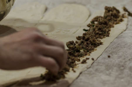 Prepearing Turkish pizza called Pide