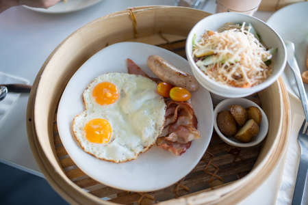 English breakfast with fried eggs, bacon, sausages, beans, の写真素材