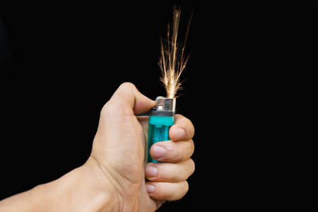 Hand with lighter igniting sparks