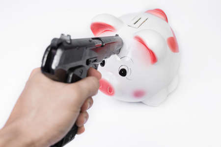 Man pointing a gun at a piggy bank no white background