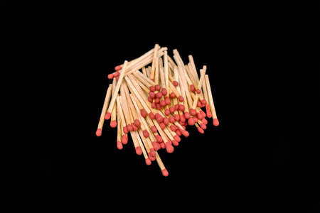 matchsticks stack up on black backgroundの写真素材