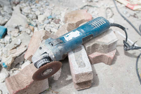Grinder machine with cutting wheel on brickの写真素材