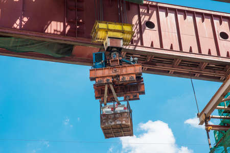 Construction site crane is lifting a concreteの写真素材