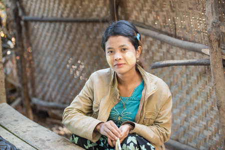 Mrauk U, MYANMAR - DEC 14, 2014: Unidentified Myanmar girl with thanaka on her smile face is happiness in Mrauk U on December 14, 2014 in Mrauk U, Myanmar.のeditorial素材