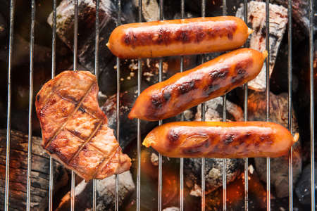 BBQ sausages and meat on the grillの写真素材